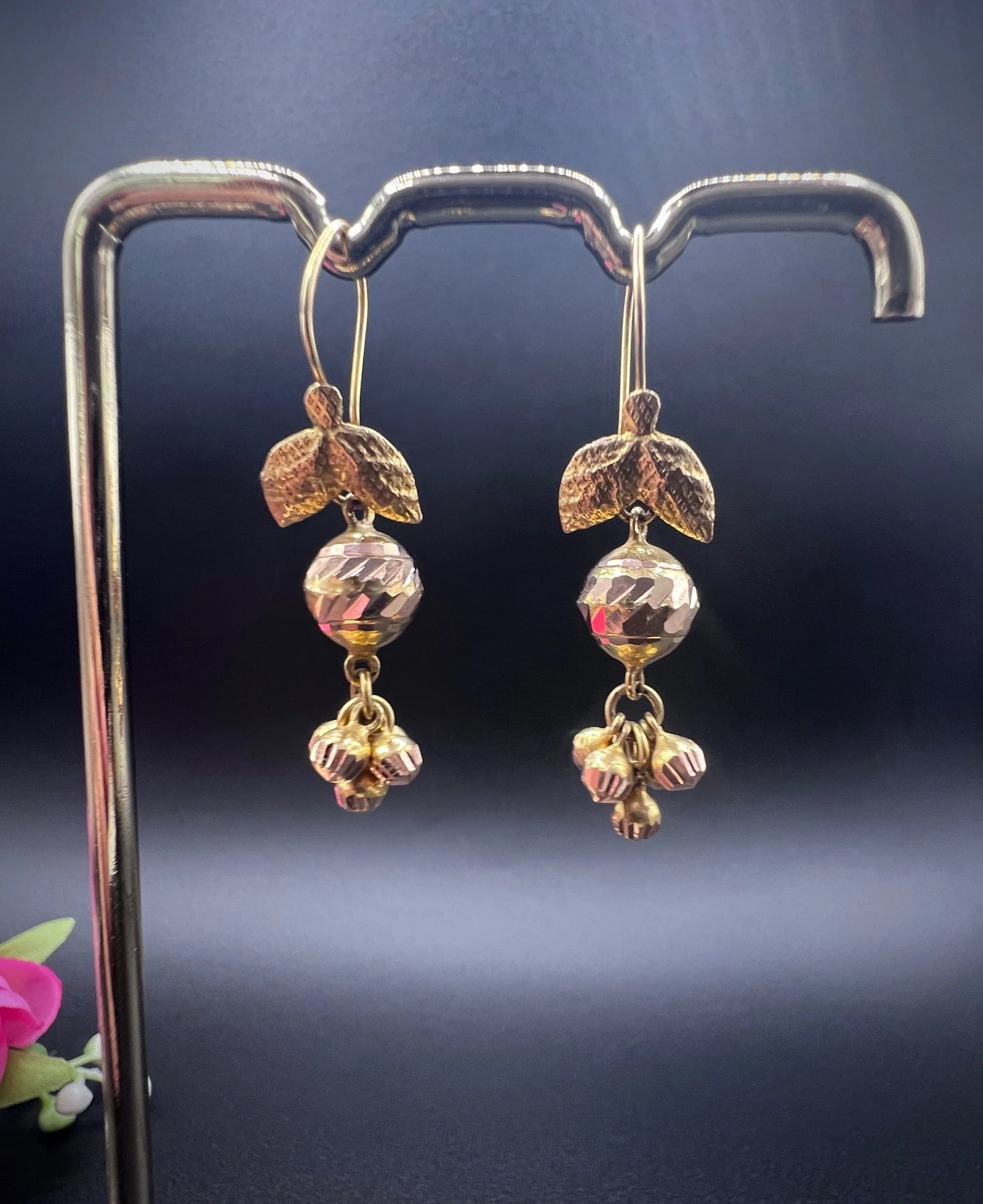 A pair of yellow gold leaf and faceted ball drop earrings with hook fittings