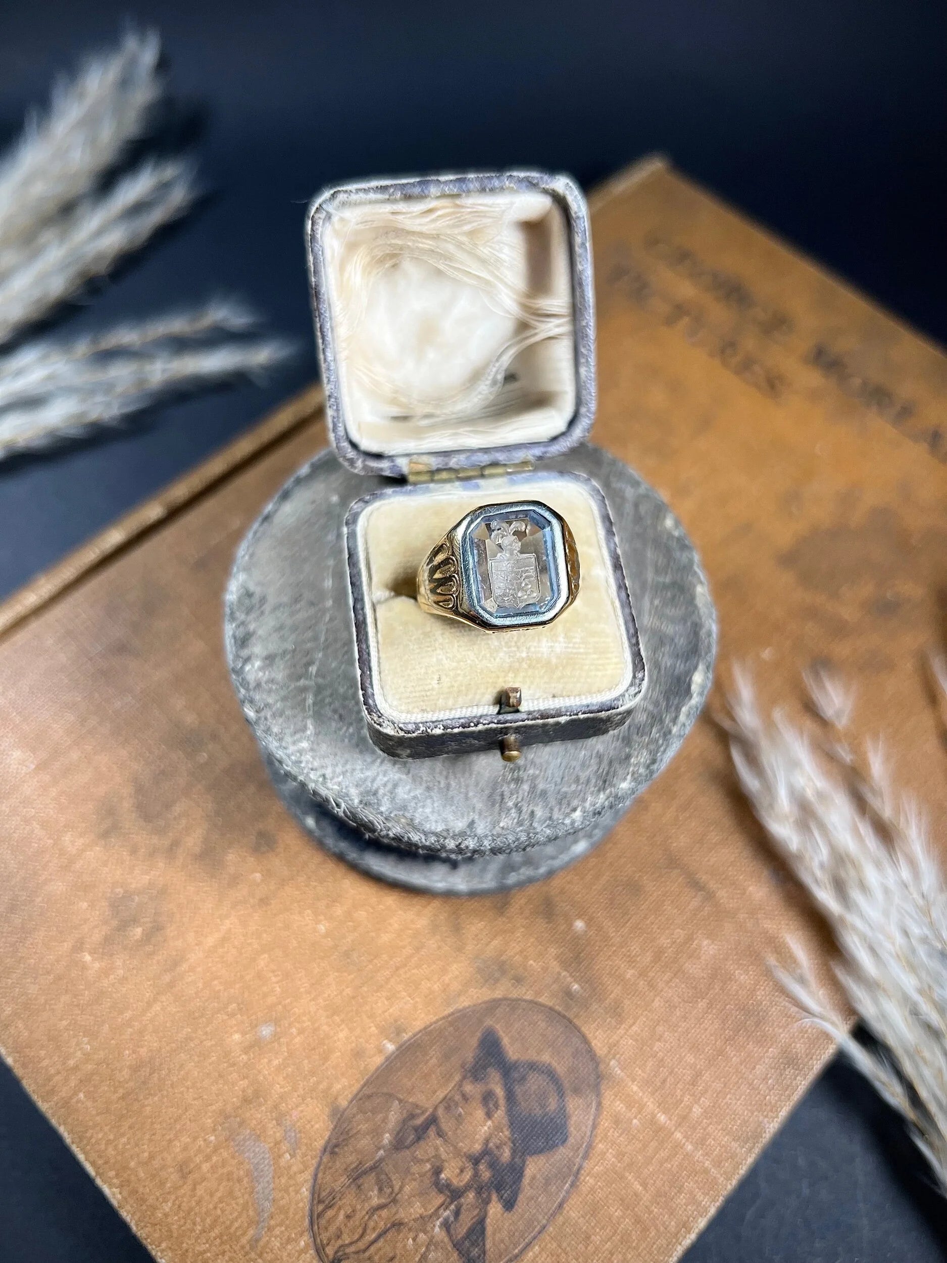 A yellow gold blue glass intaglio signet ring, in a ring box