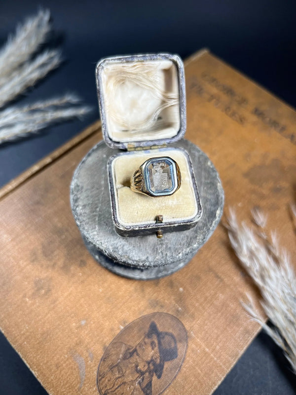A yellow gold blue glass intaglio signet ring, in a ring box