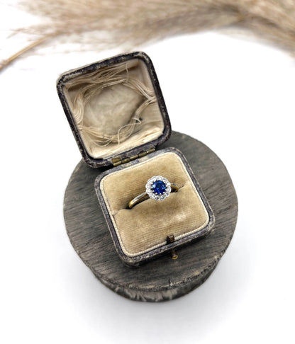 A sapphire and diamond flower cluster ring in yellow gold and platinum, in a ring box