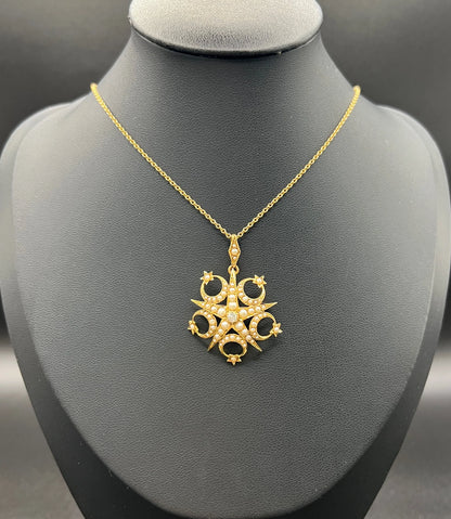 A yellow gold star and crescent brooch/pendant set with a diamond and pearls, with a gold chain
