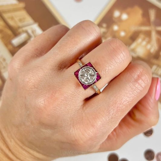 A square shaped ruby and diamond Art Deco style ring in yellow gold, modelled on a hand