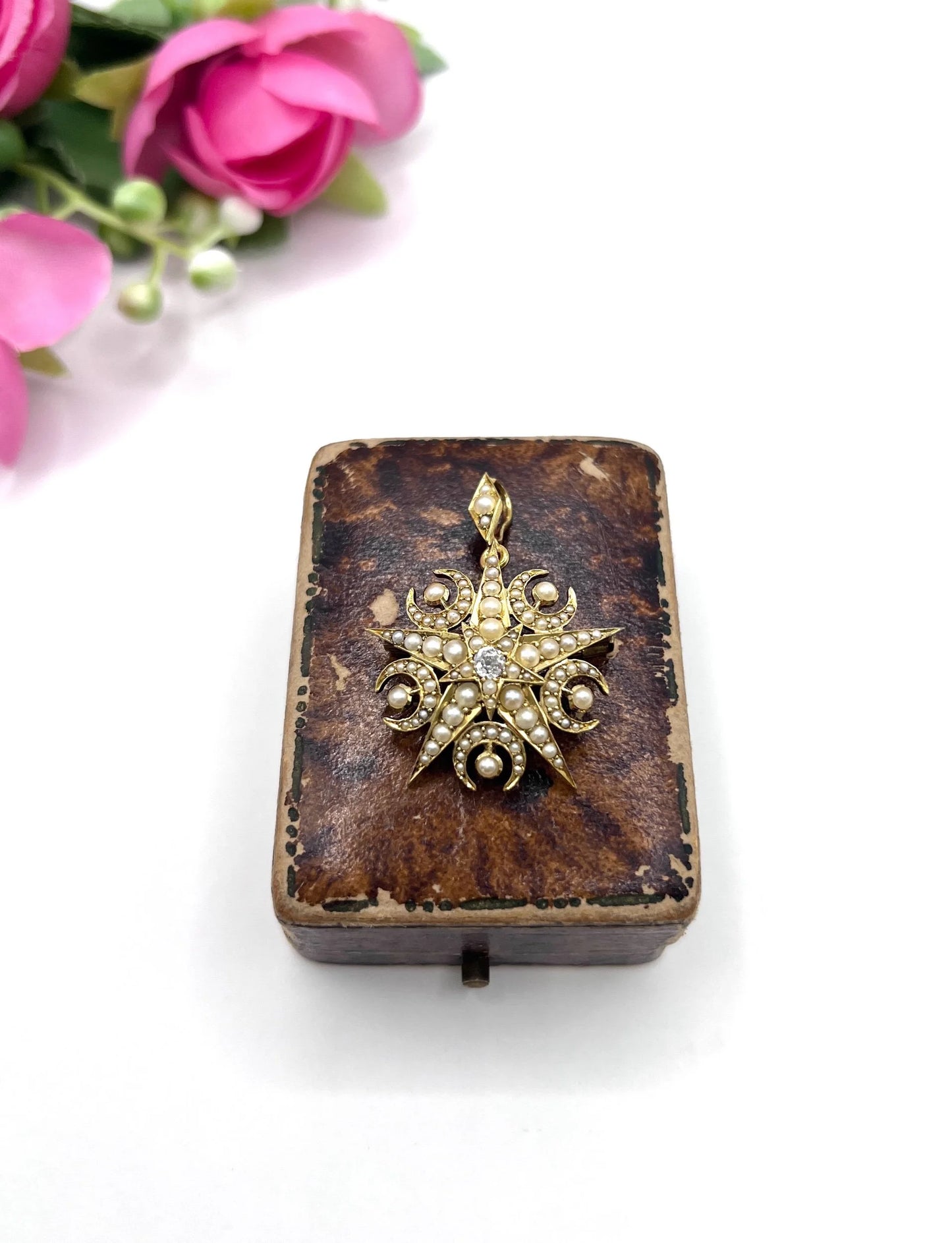 A yellow gold star and crescent brooch/pendant with pearls and a diamond centre