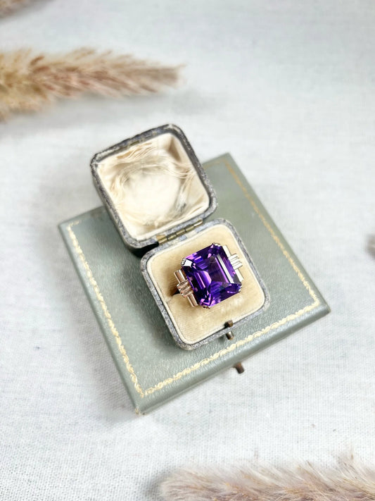 A large single stone amethyst cocktail ring in yellow gold, in a box