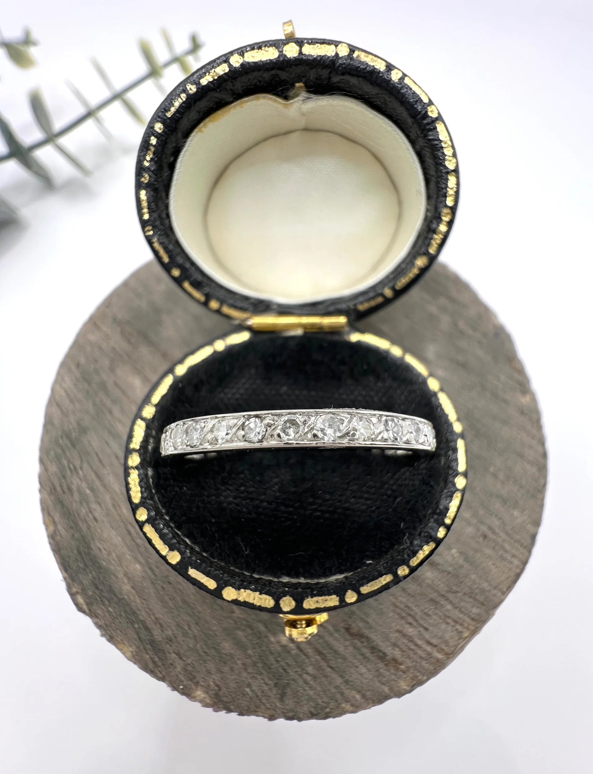 A platinum and diamond full eternity band ring, in a ring box