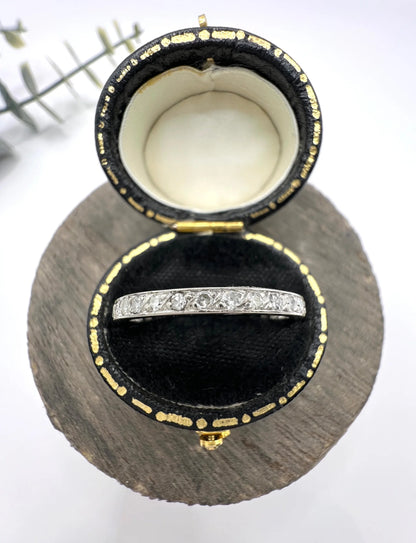 A platinum and diamond full eternity band ring, in a ring box