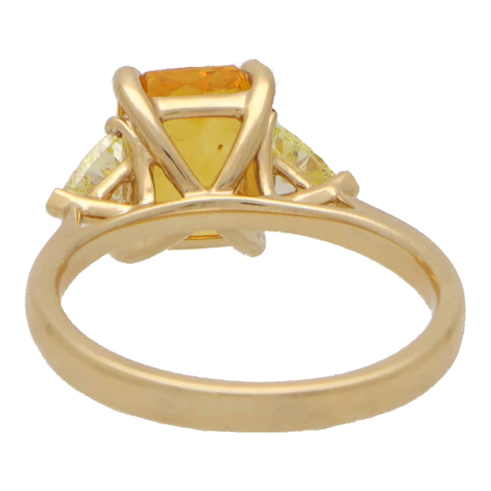 3.05ct Radiant Cut Orange Sapphire and Trillion Cut Fancy Yellow Diamond Three Stone Engagement Ring