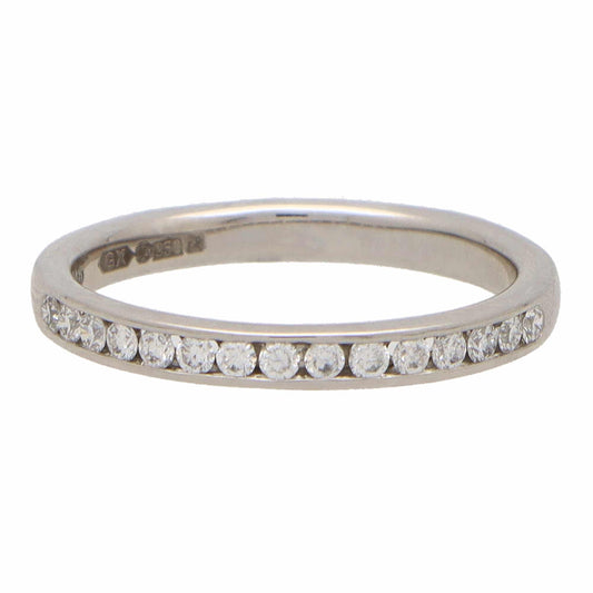 A white gold brilliant cut diamond eternity ring, on a white background