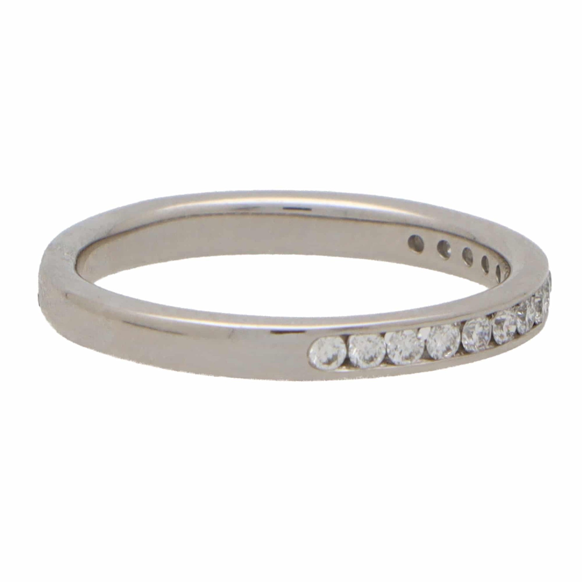 A white gold brilliant cut diamond eternity ring, on a white background