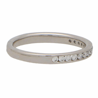 A white gold brilliant cut diamond eternity ring, on a white background