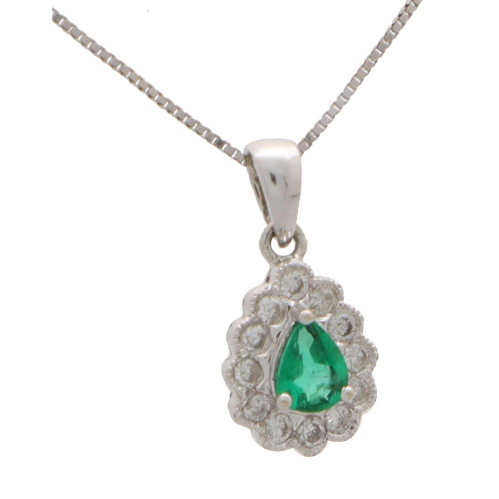 Emerald and diamond cluster pendant in white gold.