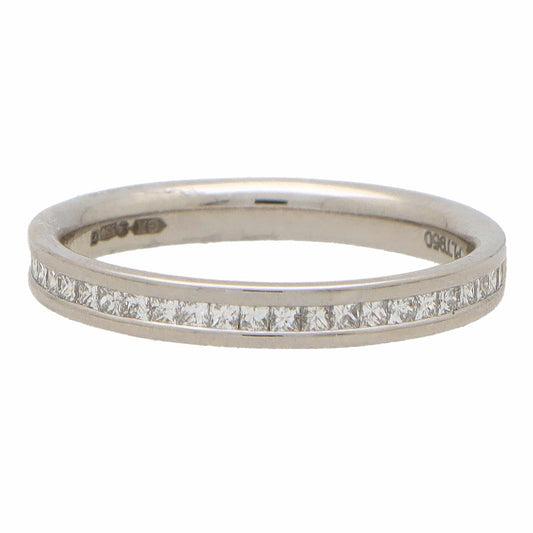 A platinum eternity ring with princess cut diamonds, on a white background