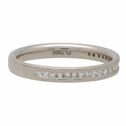 A platinum eternity ring with princess cut diamonds, stamped PLT950, on a white background