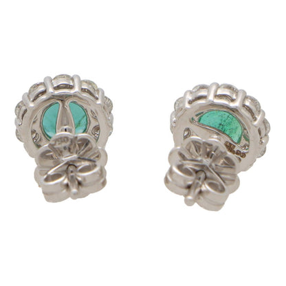 Emerald and diamond cluster earrings set in white gold.