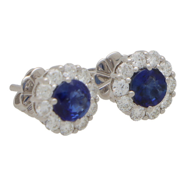 Sapphire and diamond cluster earrings set in white gold.