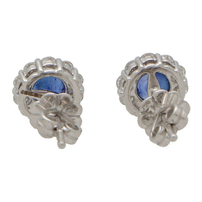 Sapphire and diamond cluster earrings set in white gold.