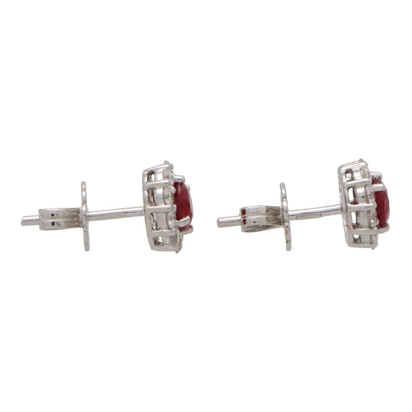 A pair of round ruby and diamond cluster earrings on a white background