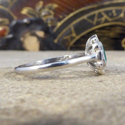 A beautiful contemporary ring featuring a 0.50ct emerald cut emerald with a diamond surround. With princess and modern brilliant cut diamonds alternating around the emerald, this ring has a total of 0.35ct diamonds allowing it to sparkle beautifully on the finger all set in platinum in a millegrain edge.