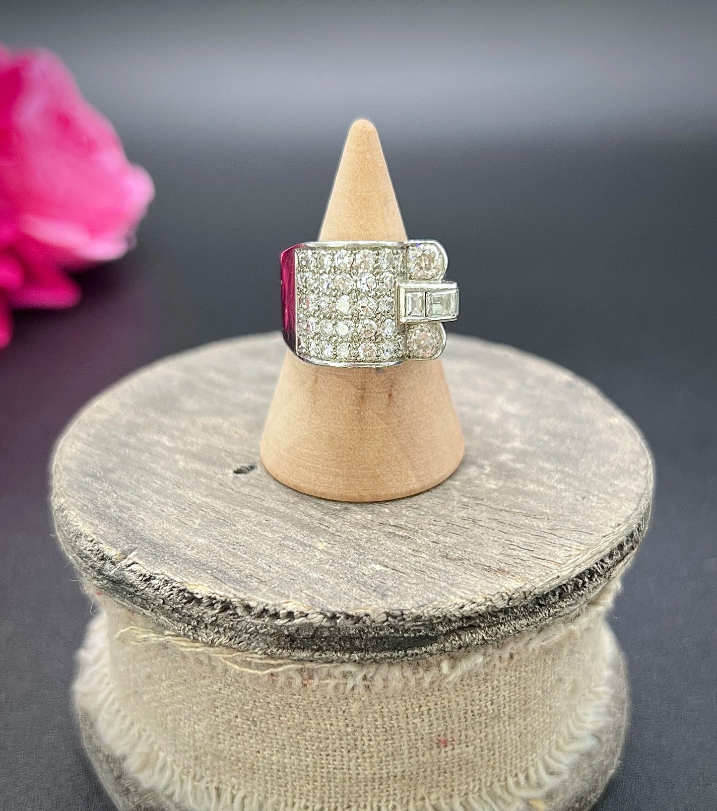 A round diamond tank style cocktail ring in platinum, on a ring cone