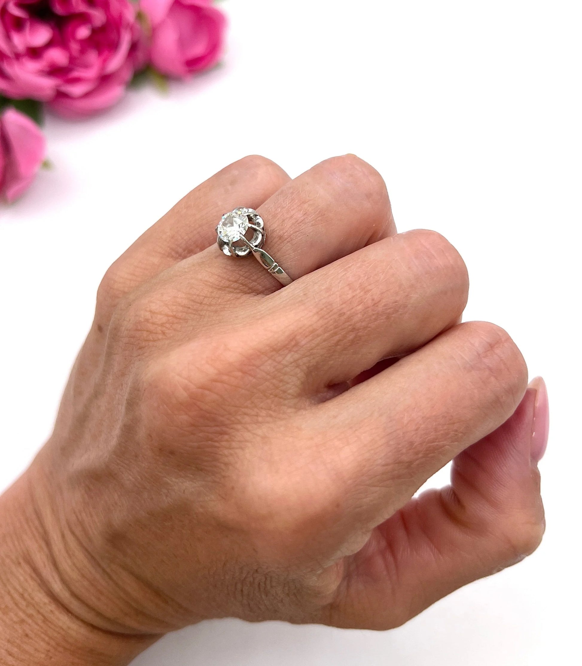 A solitaire diamond ring in platinum, modelled on a hand