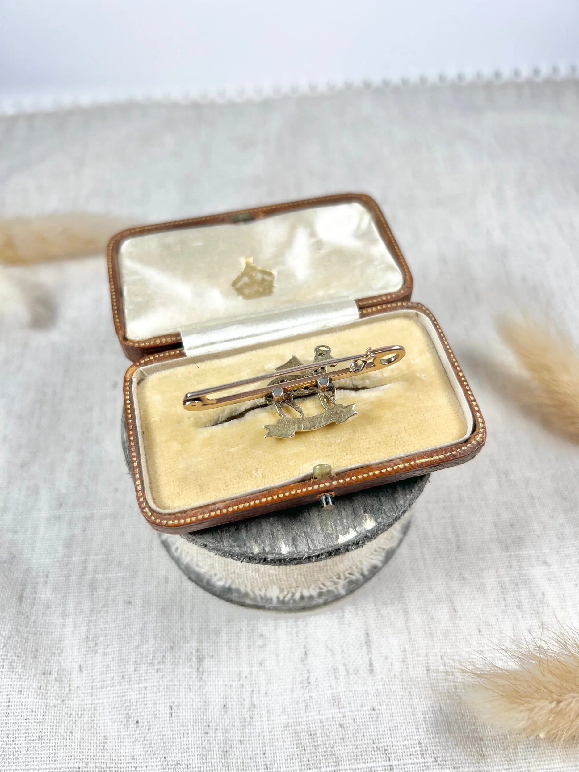 A diamond set regimental bar brooch in gold, in an antique box