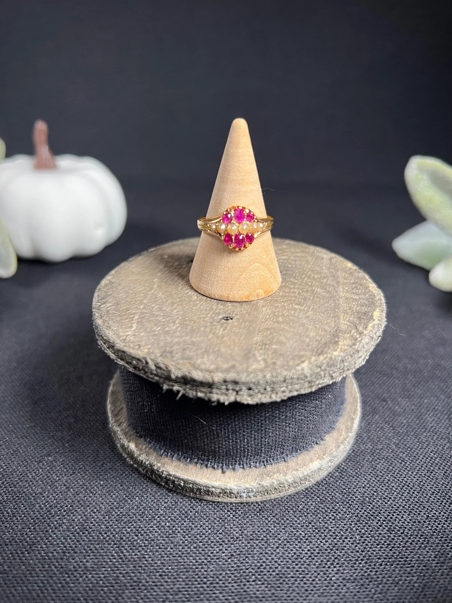 A yellow gold ruby and pearl cluster ring, on a ring cone
