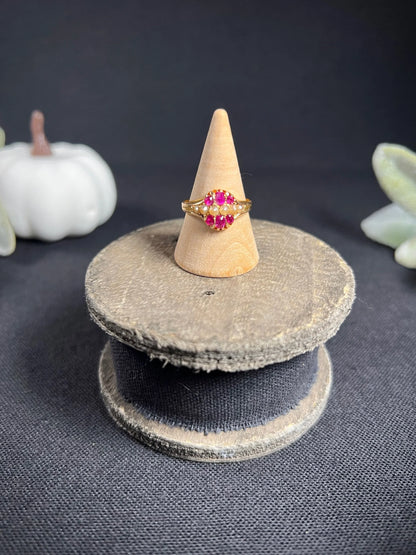 A yellow gold ruby and pearl cluster ring, on a ring cone