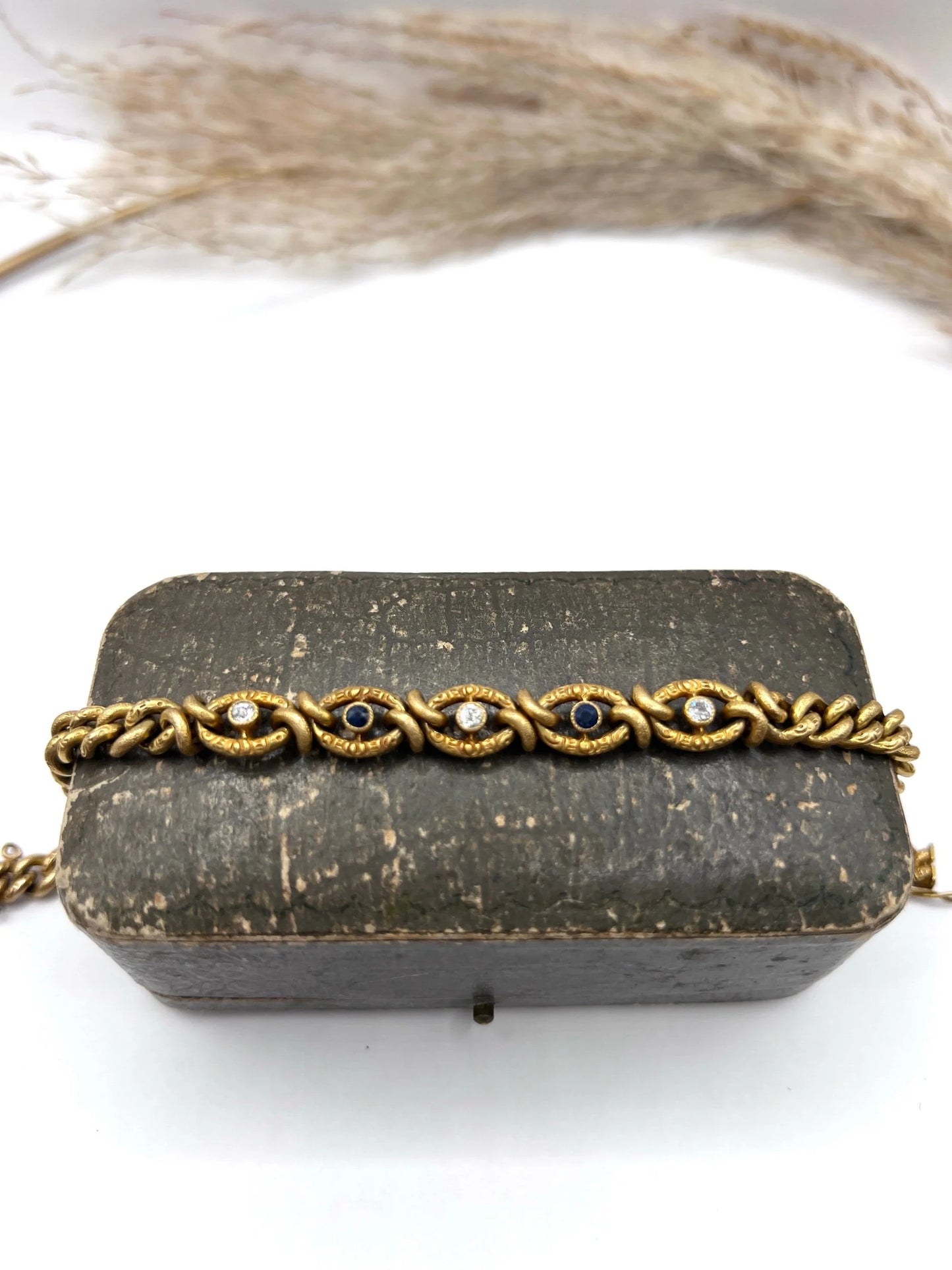 A sapphire and diamond fancy curb link bracelet in yellow gold