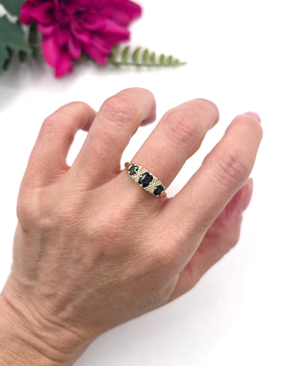 A seven stone sapphire and diamond carved ring in yellow gold, modelled on a hand