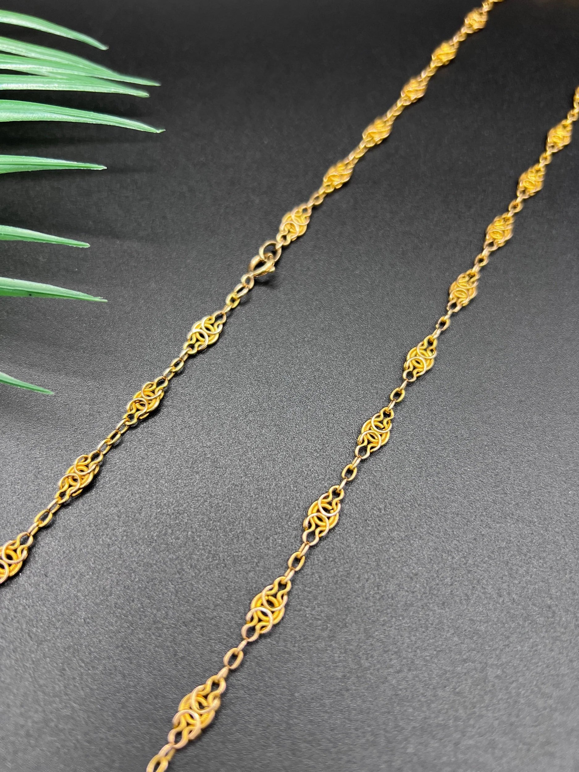 A yellow gold fancy link chain necklace