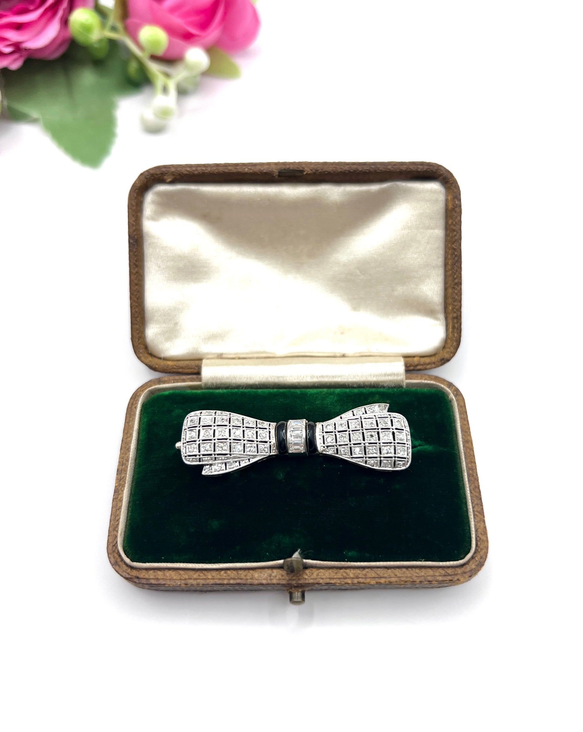 Art Deco 14 Carat White Gold Onyx and Diamond Bow Brooch, Circa 1920