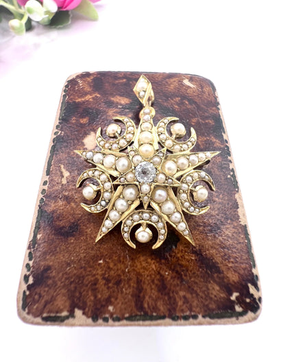 A yellow gold star and crescent brooch/pendant with pearls and a diamond centre