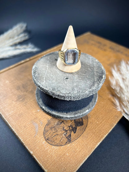 A yellow gold blue glass intaglio signet ring, on a ring cone