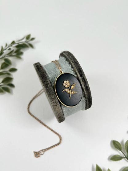 Edwardian 18 Carat Yellow Gold Onyx and Seed Pearl Flower Locket, Circa 1900