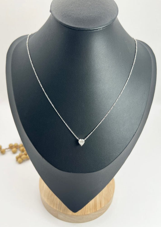 Diamond heart pendant necklace on platinum chain.