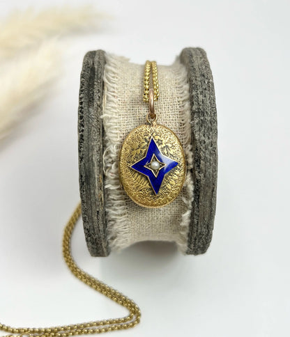 An oval yellow gold locket with a blue enamel star and seed pearl centre, with a chain