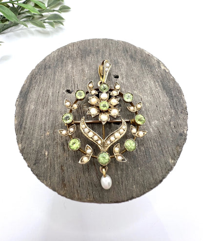 A peridot and pearl floral circle brooch/pendant in yellow gold