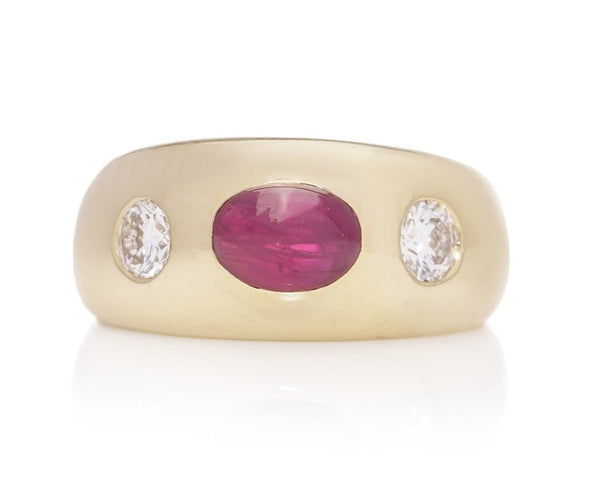 Bulgari 18ct. yellow gold gypsy set three stone ring, set with oval 1.29 cts. of Natural Burma cabochon ruby and 0.40 cts. of round Old-European cut diamonds.