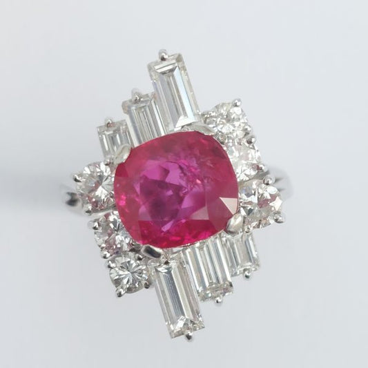 A vintage ruby and diamond cluster ring with cushion cut certified Burmese ruby surrounded by baguette- and diamond -cut ballerina cluster.