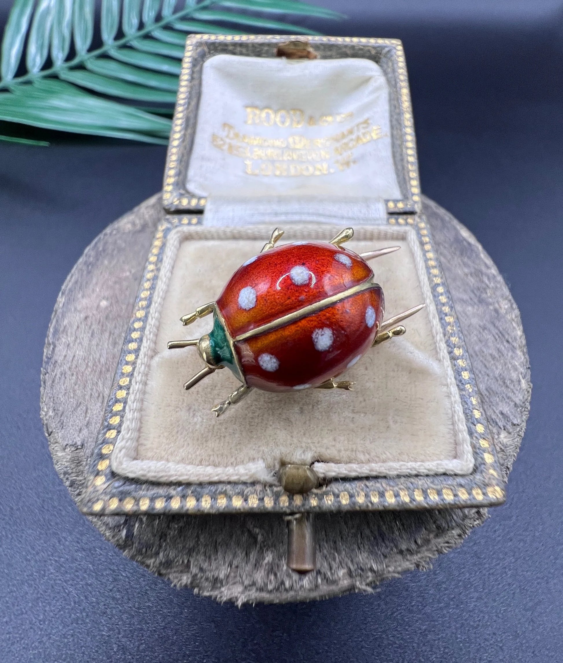 A yellow gold and enamel ladybird brooch