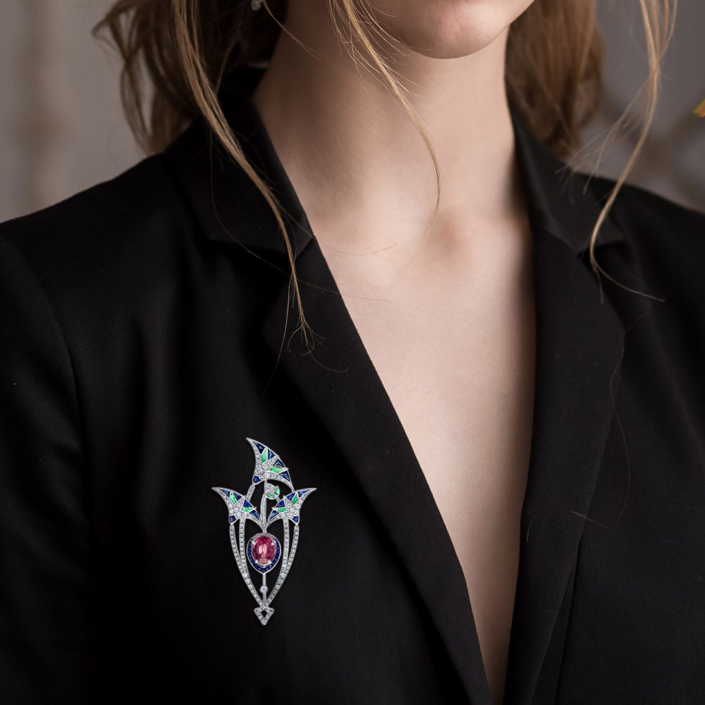 3.35ct Pink Tourmaline Sapphire Emerald and Diamond Brooch depicting a central pink lotus flower bud under its leaves in 18ct white gold