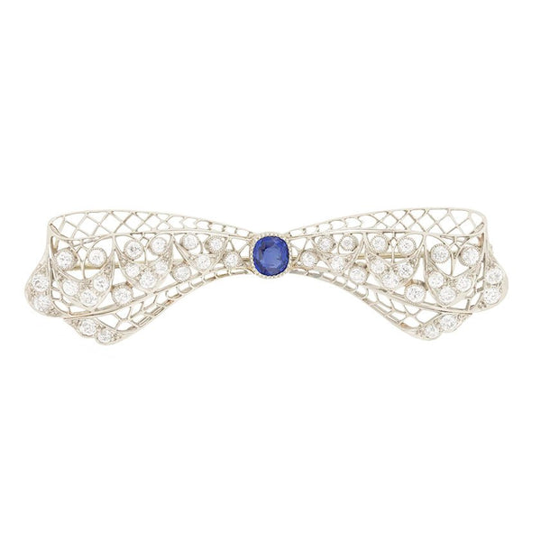 Vintage Antique Art Deco 3.4ct Old Cut Diamond and Sapphire Bow Brooch in Platinum, 1ct old cushion cut sapphire in diamond encrusted platinum decorative pierced framework with original antique velvet-lined fitted box. Circa 1920s