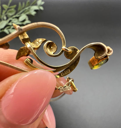Close-up of 15CT stamps on a yellow gold pendant necklace