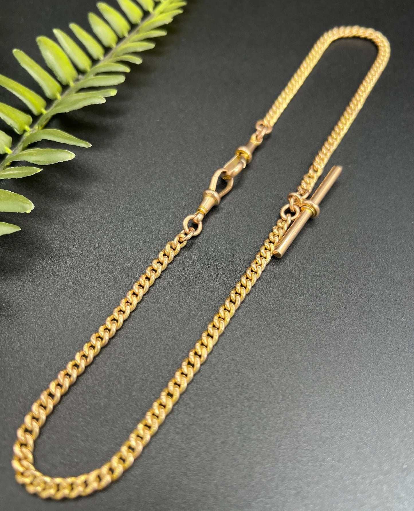 A yellow gold curb link Albert watch chain