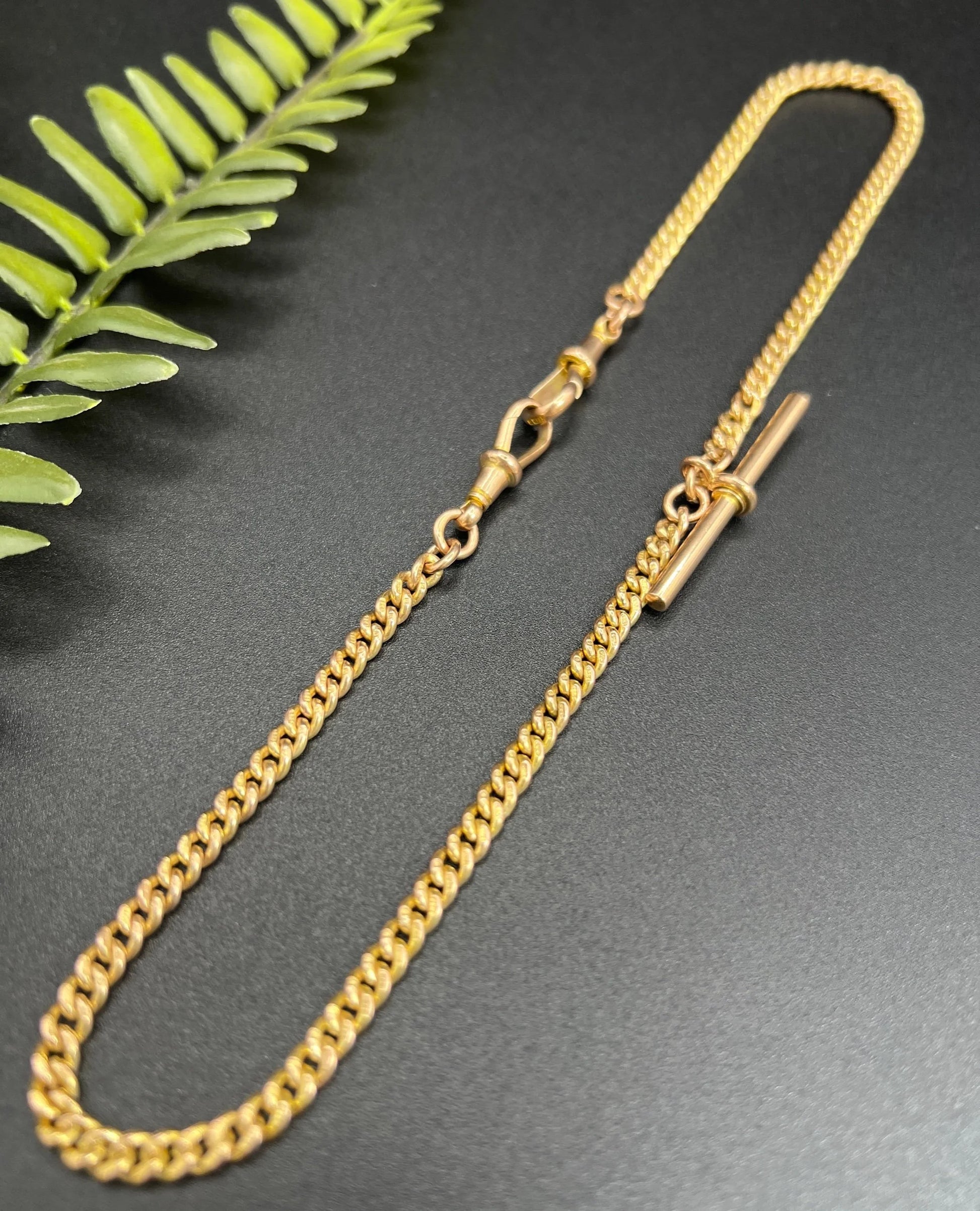 A yellow gold curb link Albert watch chain