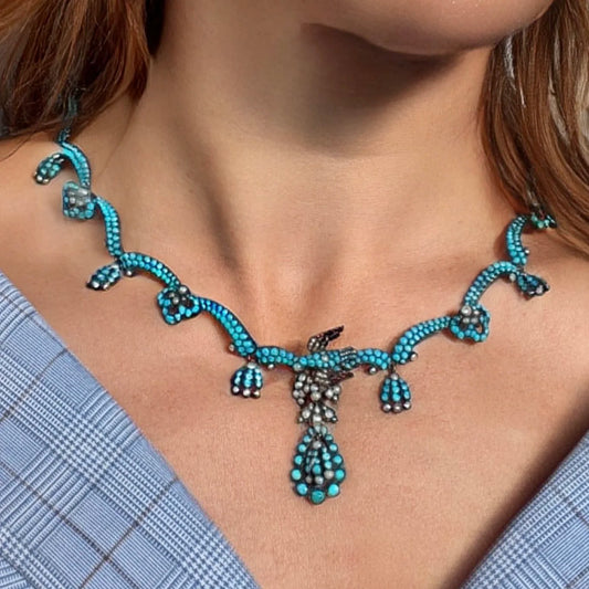 An antique turquoise bead and pearl fancy necklace with a bird motif