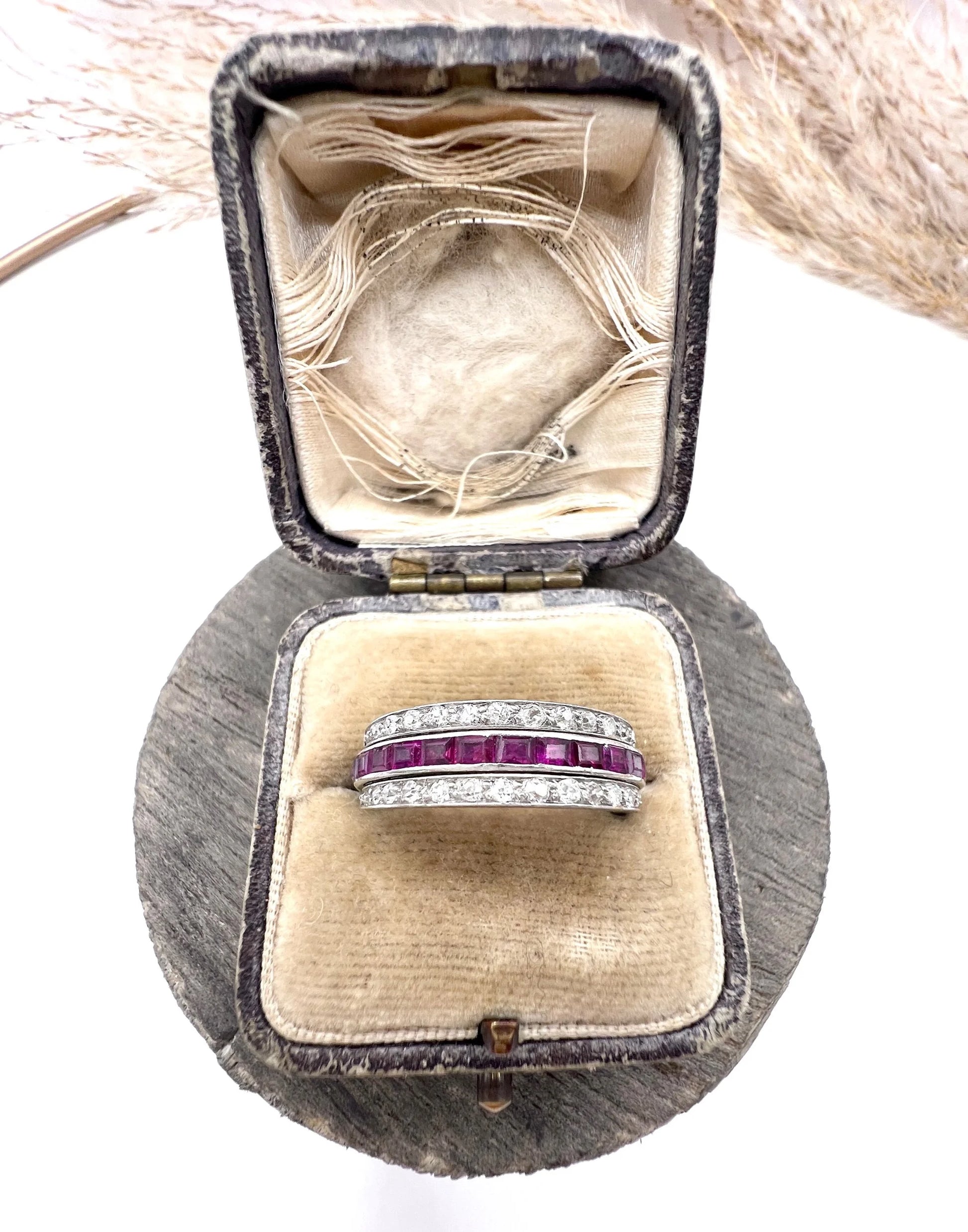 A platinum night and day flip band ring set with diamonds, sapphires and rubies, in a ring box