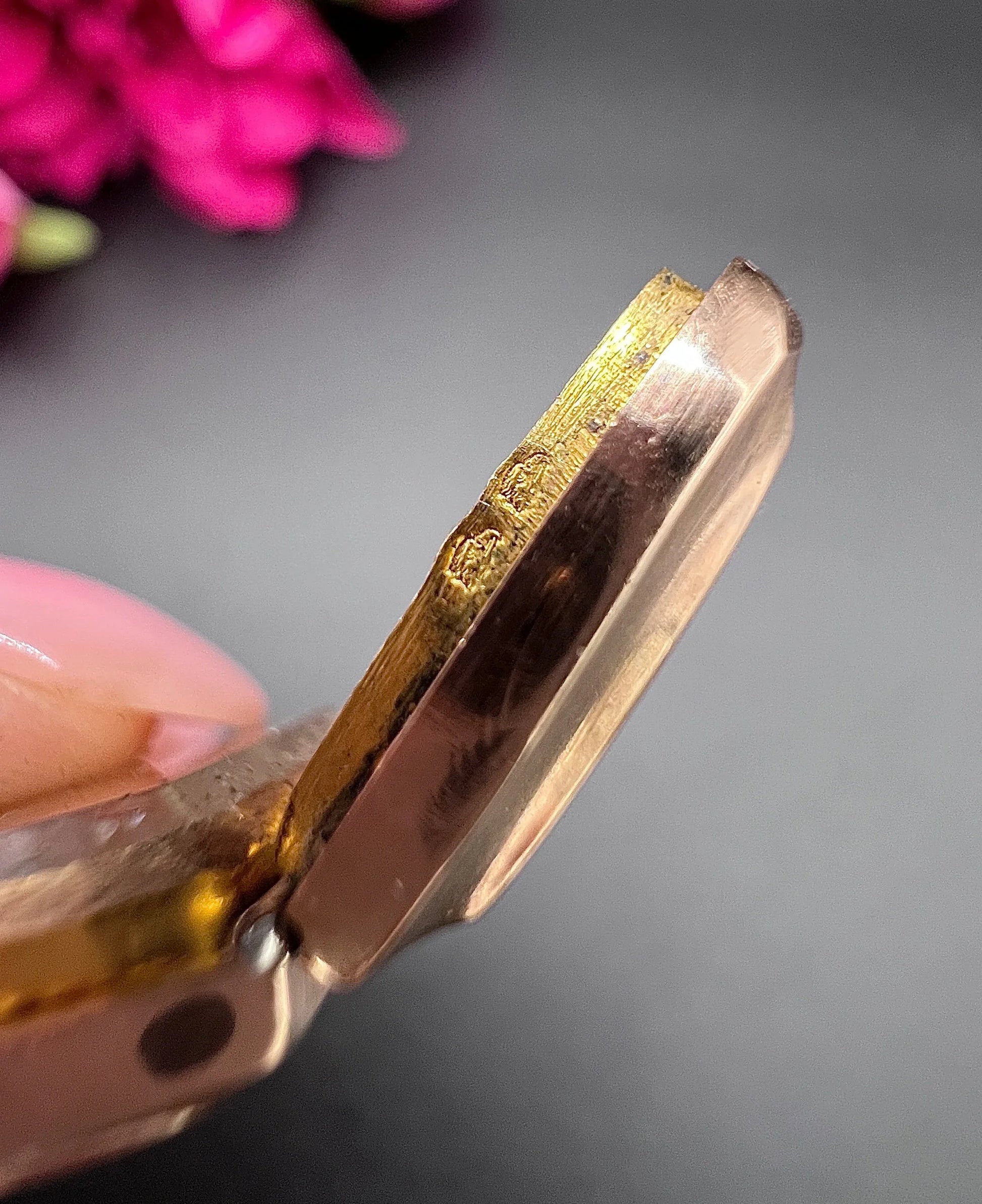 Close-up of French stamps on a yellow gold locket