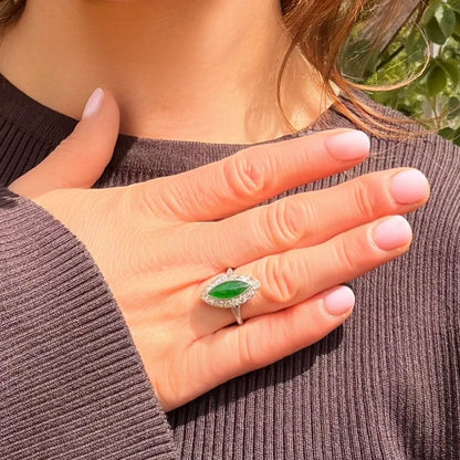 A jade and diamond navette shaped cluster ring in platinum, modelled on a hand