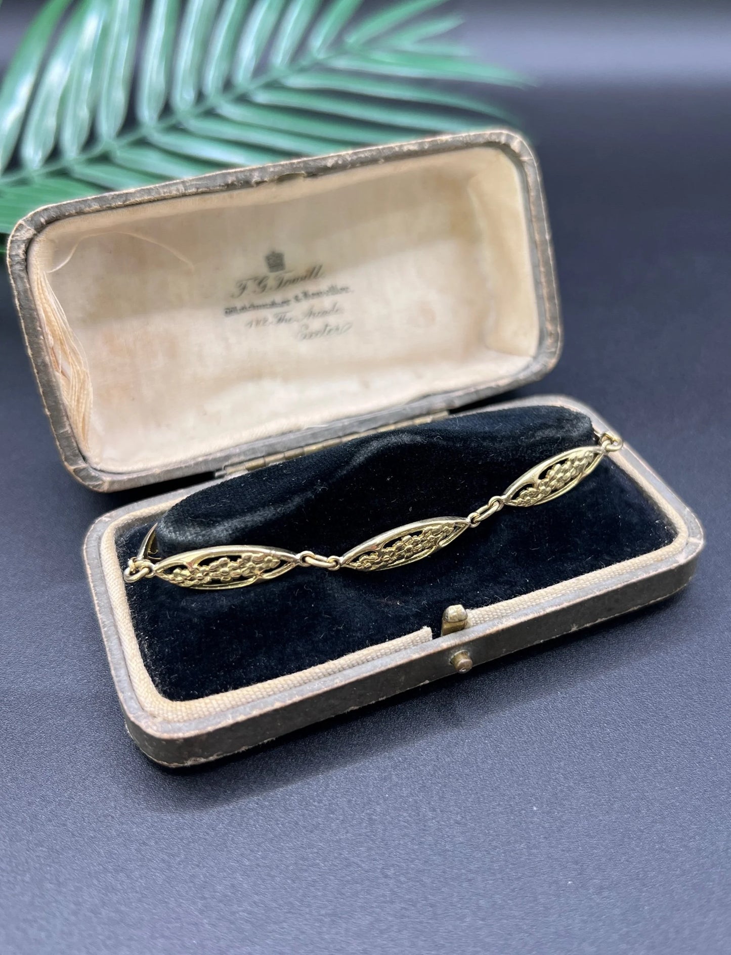 A yellow gold floral link bracelet, in a bracelet box